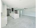 Open-concept living area with sleek tile flooring, island and modern fixtures at 20295 Lorenzo Ave, Port Charlotte, FL 33952