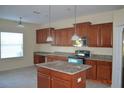 Kitchen with granite counters, island and stainless steel appliances at 20420 Carolina Cherry Ct, Tampa, FL 33647