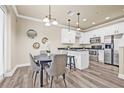Well-lit dining area adjacent to a modern kitchen with stainless steel appliances and bar stool seating at 215 S Westland Ave # 3, Tampa, FL 33606