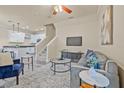Bright living room boasts stylish décor, open floor plan, ceiling fan and gray floors at 215 S Westland Ave # 3, Tampa, FL 33606