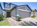 Inviting two-story home featuring a two-car garage and beautifully maintained front yard at 2723 Garden Falls Dr, Brandon, FL 33511