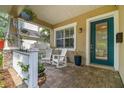 Inviting front porch with rocking chairs and a beautifully painted front door at 3109 W Granada St, Tampa, FL 33629