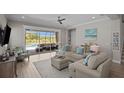 Bright and airy living room with sliding glass doors leading to the pool area, featuring comfortable seating and stylish decor at 3161 Satilla Loop, Odessa, FL 33556