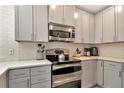 Modern kitchen featuring stainless steel appliances and light gray cabinets at 3412 W San Juan St # B, Tampa, FL 33629