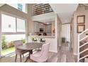 Eat-in kitchen with stainless appliances, breakfast bar, and light wood flooring at 3412 W San Juan St # B, Tampa, FL 33629