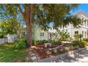 Charming home featuring a light green exterior and well-maintained landscaping, enhancing its curb appeal at 427 21St N Ave, St Petersburg, FL 33704