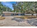 Charming single-story home featuring a spacious driveway, two-car garage, and mature landscaping at 525 Gornto Lake Rd, Brandon, FL 33510