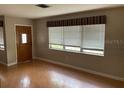View of the living room with hardwood floors and several windows at 5991 42Nd N Ave, St Petersburg, FL 33709