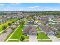 A high aerial view shows the home in a well-planned neighborhood with green lawns and fenced yards at 6670 Paden Wheel St, Zephyrhills, FL 33541