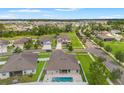 Drone shot features the home with a private pool and landscaped backyard in a leafy residential area at 6670 Paden Wheel St, Zephyrhills, FL 33541