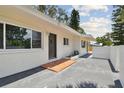 Inviting front entrance with unique tile and a modern door and hardware at 695 Sunset Dr, Tarpon Springs, FL 34689