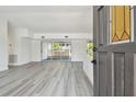 Open living room featuring light gray flooring and sliding glass doors to the outside at 695 Sunset Dr, Tarpon Springs, FL 34689