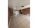 Open concept living room with tile flooring and a view of the kitchen at 7021 Mayfield Dr, Port Richey, FL 34668