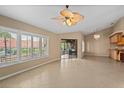 Open living room featuring tile floors, bright windows, and sliding glass doors to the patio at 77 Gulfwinds Dr, Palm Harbor, FL 34683