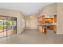 Spacious living room with tile floors, a chandelier, and a view of the screened-in patio at 77 Gulfwinds Dr, Palm Harbor, FL 34683