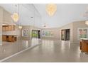 Bright living room with elegant chandeliers, tiled floors, and a mirrored wall at 77 Gulfwinds Dr, Palm Harbor, FL 34683