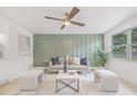 Comfortable living room boasts modern decor, a plush sofa, stylish ottomans, and a large window for natural light at 7991 54Th N St, Pinellas Park, FL 33781