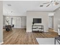 Bright living room featuring wood floors, a ceiling fan, and access to the outdoor patio at 8175 Sturbridge # 8175, Weeki Wachee, FL 34613
