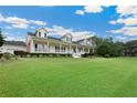 Spacious home with a long porch, beautiful greenery and large lawn at 9830 Caribou Trl, Dade City, FL 33525