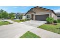 Single-Gathering home boasts a well-maintained lawn and a long driveway at 11314 American Holly Dr, Riverview, FL 33578
