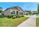 Beautiful home with stone accents and well-manicured landscaping, enhancing its curb appeal at 11314 American Holly Dr, Riverview, FL 33578