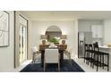 Bright dining room with modern décor, including seating for six, stylish light fixtures, and stainless steel appliances in background at 11737 Brae Way, Dade City, FL 33525
