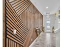 Stunning entryway featuring modern wood accent wall and an elegant chandelier at 12650 Shetland Walk Dr, Lithia, FL 33547