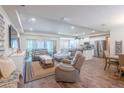 Comfortable living room with hardwood floors seamlessly connecting to the modern kitchen, perfect for entertaining at 15207 Taralane Ave, Brooksville, FL 34604