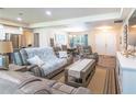 Bright and airy living room featuring hardwood floors, neutral tones, and an inviting atmosphere, perfect for relaxation at 15207 Taralane Ave, Brooksville, FL 34604