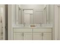 Bathroom featuring double vanity with white marble countertop and modern chrome faucets at 18477 Serene Lake Loop, Lutz, FL 33548