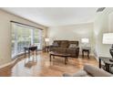 Cozy living room with hardwood floors, large window, and comfortable furnishings at 2484 Whitman St, Clearwater, FL 33765