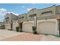 Charming townhouse with a two-car garage, elegant tile roof, and nicely manicured landscaping at 2914 W Gandy Blvd # C, Tampa, FL 33611