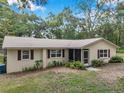 Quaint one-story home with inviting facade and mature trees enhancing curb appeal at 316 Jenkins Ave, Brooksville, FL 34604