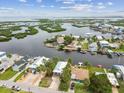 Aerial shot of waterfront homes surrounded by canals, offering scenic views and boating access at 3285 Minnow Creek Dr, Hernando Beach, FL 34607