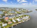 Aerial view of waterfront neighborhood showcasing community layout, boating access, and nearby amenities at 3285 Minnow Creek Dr, Hernando Beach, FL 34607