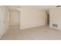The living room has light-colored tile flooring and fresh paint at 3404 Dahlia Pl, Largo, FL 33771