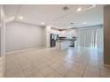 Spacious open-concept kitchen with white cabinets, granite countertops, stainless steel appliances, and a modern island at 34187 Rogallo Ln, Wesley Chapel, FL 33545