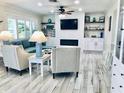 Inviting living room with a modern fireplace, built-in shelves, and stylish seating at 4103 Gulf Blvd # 210, St Pete Beach, FL 33706