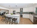 Modern kitchen featuring white cabinets, stainless steel appliances, large island with seating at 4106 W Fielder St, Tampa, FL 33611