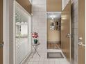 Bright foyer with tiled floors, a view of an elegant mirror, and a table with an orchid at 4304 N River View Ave, Tampa, FL 33607