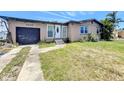 Charming single-story home with a front lawn and a one-car garage, set against a bright blue sky at 4709 Mineola St, Bradenton, FL 34207