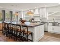 Open kitchen boasts a spacious island, modern pendant lighting, and sleek white cabinetry at 4710 W Tambay Ave, Tampa, FL 33611