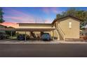 Exterior view of the building with covered parking spaces available, and stairs to the units at 501 E Bay Dr # 102, Largo, FL 33770