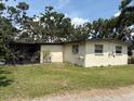 The backyard features a screened-in porch and a simple exterior at 5279 Eureka Springs Rd, Tampa, FL 33610