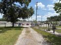 Long gravel driveway leading to the property with ample parking space at 5279 Eureka Springs Rd, Tampa, FL 33610