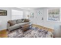 Inviting living room featuring wood floors, a comfortable sofa, and ample natural light at 750 49Th N Ave, St Petersburg, FL 33703