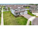 A high angle perspective of a lovely home with a green lawn and view of pond at 7628 Surf Reed Way, Wesley Chapel, FL 33545