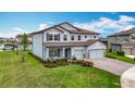 Charming two-story home boasts a spacious three-car garage and well-maintained front yard at 7628 Surf Reed Way, Wesley Chapel, FL 33545