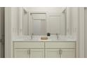 Elegant bathroom featuring a double vanity with marble countertop, sleek fixtures, and a well-lit shower at 9456 Gladsome Dr, Land O Lakes, FL 34637