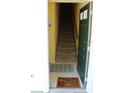 View of the tiled entryway showing stairs and welcome mats at 9722 Indian Key Trl # 116, Seminole, FL 33776